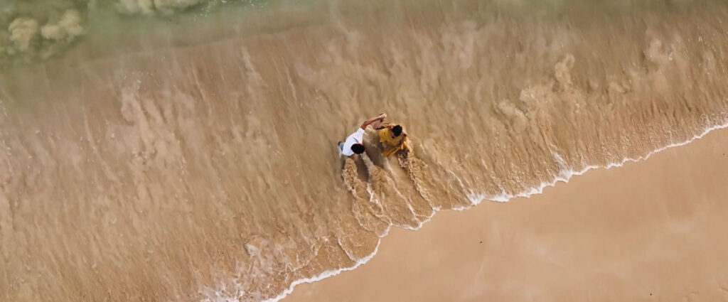 Couple on an Oahu beach after proposal